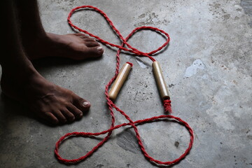A man is Skipping. Jumping rope, also known as skipping, is a highly effective and accessible full-body workout with a wide range of benefits for your physical and mental health.
