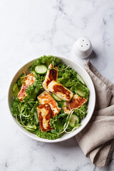 Cucumbers, sprouts and green leaves salad with fried halloumi.