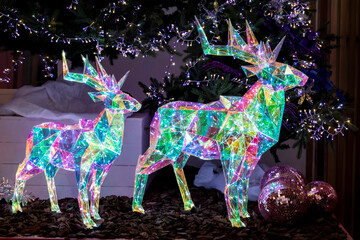 festive outdoor decoration for Christmas. glowing Christmas deer led figures, selective focus