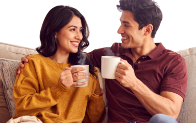 - Romantic Couple Sitting Together with Coffee Mugs