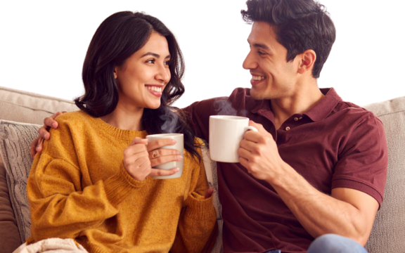 - Romantic Couple Sitting Together with Coffee Mugs - Powered by Adobe