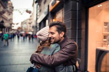 Couple embracing in city street