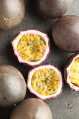 Fresh passion fruits on grey table, flat lay