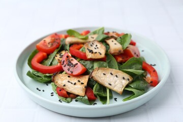 Tasty salad with eryngium mushrooms, vegetables, spinach and sesame on white table, closeup