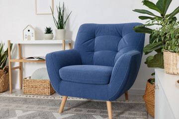 Comfortable blue armchair in living room. Interior design