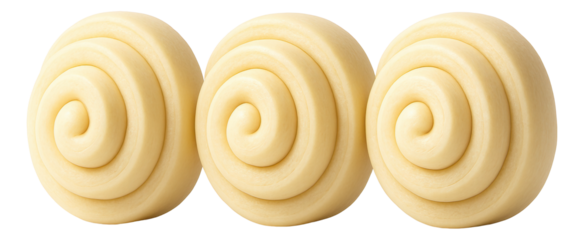 A close-up of raw ravioli with decorative edges, resting on a floured cutting board