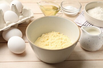 Different ingredients for corn bread on light wooden table, closeup