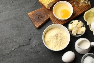 Cornbread preparation. Different ingredients on black textured table, flat lay. Space for text