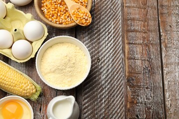 Cornbread preparation. Different ingredients on wooden table, flat lay. Space for text