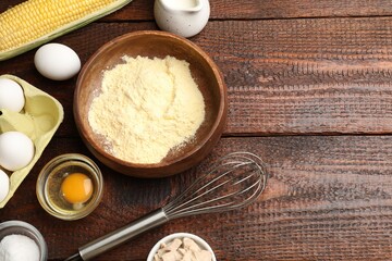 Making cornbread. Different ingredients and metal whisk on wooden table, flat lay. Space for text