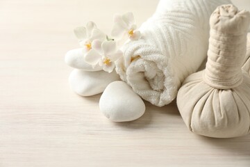 Beautiful spa composition with herbal bags on white wooden table, closeup. Space for text