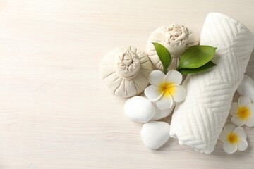 Beautiful spa composition with herbal bags on white wooden table, flat lay. Space for text