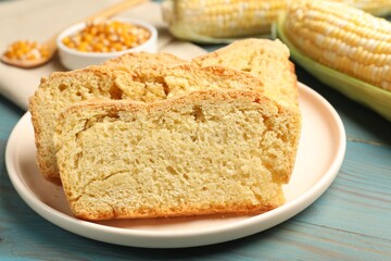 Freshly baked cornbread, cobs and seeds on light blue wooden table, closeup