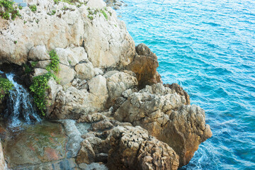 Beautiful view of clean water and stones on shore at summer