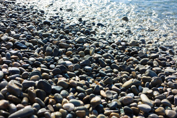 Beautiful view of wavy sea and pebbles on beach