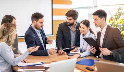 Engineers are discussing project on brown blueprint sketch while consulting in office during construction planning