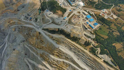 Aerial of open mine and heavy mining equipment