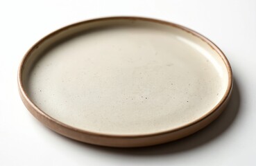 Flat ceramic plate on white background. Minimalist design. Round shape, light beige, brown edge. Simple home decor, tableware, crockery, serving food. Top view, studio shot.