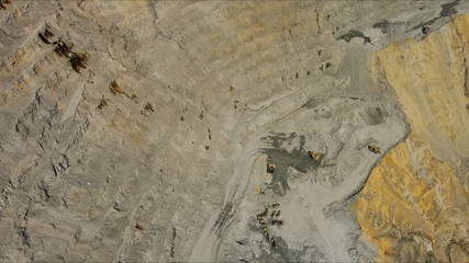 Aerial of open mine and heavy mining equipment