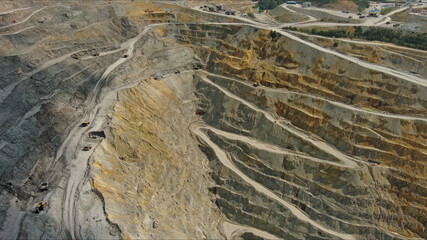 Aerial of open mine and heavy mining equipment
