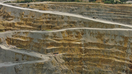 Aerial of open mine and heavy mining equipment