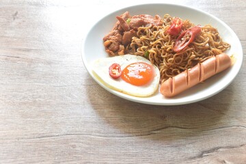 fried instant noodles in mala sichuan sauce topping egg and chicken on plate
