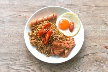 fried instant noodles in mala sichuan sauce topping egg and chicken on plate