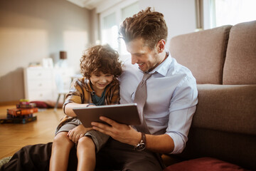 Father and son enjoying tablet together