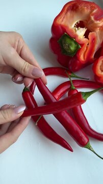 Chili pepper Hands open red bell pepper into two halves close-up top view. High quality 4k footage