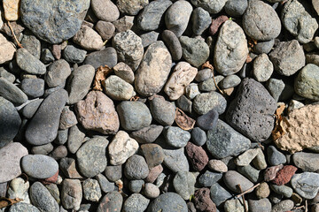 A pile of rocks with a few brown leaves scattered on top