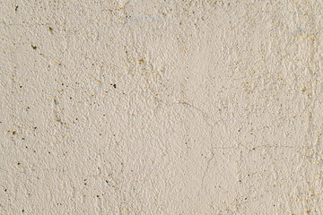 A wall with a white background and a few small holes