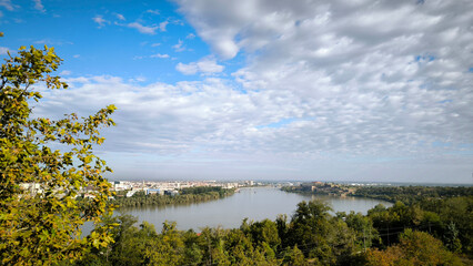 landscape by the Danube river in Novi Sad in autumn, with beautiful small white clouds