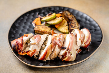 Bacon wrapped chicken breast with grilled vegetables