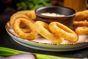 Golden crispy onion rings with sauce