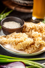 Crispy fried chicken strips with sauce