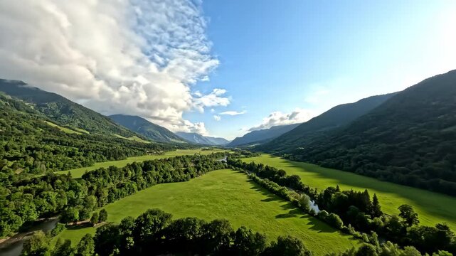 Wide-angle dolly shot descending into a lush, vibrant green valley with soft white clouds drifting slowly overhead vista, fields, slow motion