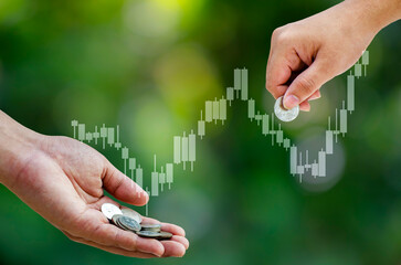 Saving and Investment with Hand Giving and Receiving Coins over Financial Growth Chart Background