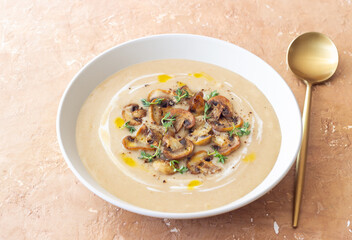 Mushroom cream soup with champignons and thyme. Healthy diet. Vegetarian food.