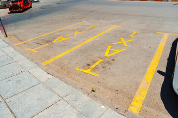 Taxi parking area with distinct markings at a busy urban intersection on a sunny day