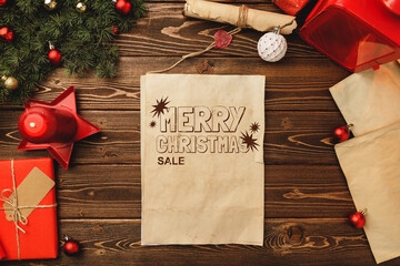 Festive Christmas sale announcement on rustic wooden table with decorations