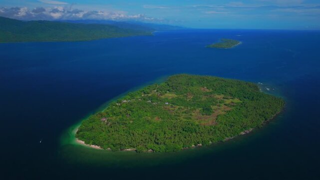Yuo Island remote pristine untouched tropical Mushi island coastline village Wewak Madang Cape Wom Papua New Guinea aerial drone PNG dry season summer morning bleu sky power fishing boat circle left