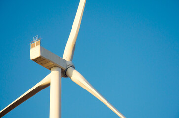 Renewable energy. Wind power plant in autumn field during sunrise.Building wind turbines. Wind turbine base.
