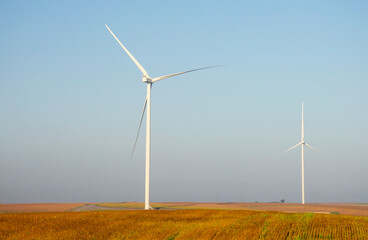 Renewable energy. Wind power plant in autumn field during sunrise.Building wind turbines. Wind turbine base.