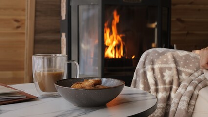 Slow life moment with hot coffee near fireplace calm evening shows warmth and reflection fire brings peace and gentle glow fire creates cozy balance fire becomes symbol of harmony in quiet life