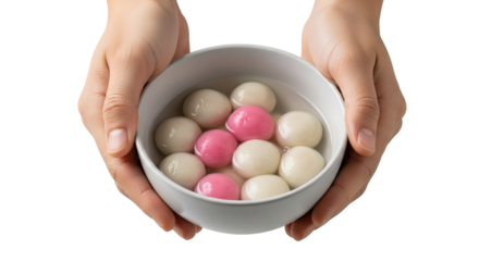 Two hands holding a bowl of tangyuan with colorful rice balls during a festive celebration