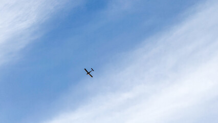 Single glider dances across cerulean sky, whispering tales of freedom, perfect for World Aviation Day and Sky Awareness Week