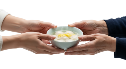 Hands transfer tangyuan bowl to elder in a warm gesture of care and respect during a family gathering