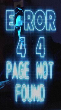 Hacker Typing in Dark Room Hoodie and Mask with Error 404 Message