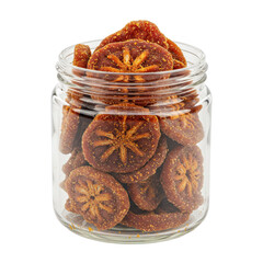Preserved bael fruit slices in glass jar, star-shaped segments, textured surface isolated on white background