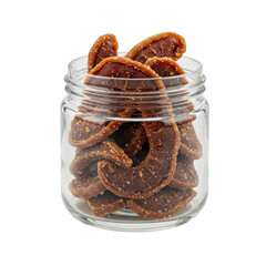 Brown, sweet treats in a clear glass jar isolated on white background